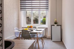 a kitchen with a table and chairs and a window at AVA City Center SATU MARE in Satu Mare