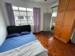 a bedroom with a bed and a large window at Peach Villa @ Putatan in Kota Kinabalu