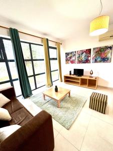 a living room with a couch and a coffee table at SR Palmela Village Studios II in Quinta do Anjo