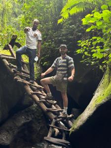 two men standing on a bridge in the jungle at Safari villa in Arusha