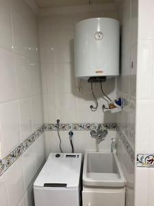 a small kitchen with a stove and a sink at Apartamentos Costa Blanca in Playa de Gandia