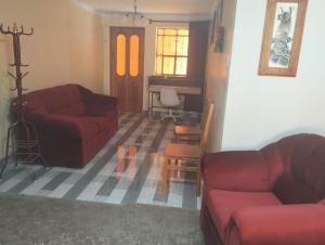 a living room with two couches and a table at Casa Abuelito's Andean Haven in Huaraz