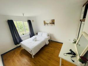 a bedroom with a bed and a desk and a window at Double Room near Canary Wharf 32 in London