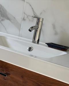 a bathroom sink with a silver faucet on it at Le Clos Du Moulin 2 - Maison et jardin, proche Avignon, en Provence in Entraigues-sur-la-Sorgue