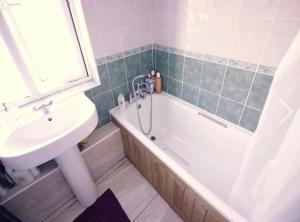 a bathroom with a sink and a bath tub and a sink at Double Room near Canary Wharf 32 in London