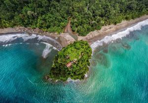 an aerial view of a small island in the ocean at Morro Terco Hotel Nuquí in Nuquí