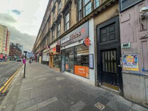 an empty street in a city with a store at City Centre 5 Bedroom Flat on Sauchiehall Street in Glasgow