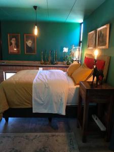 a bedroom with a bed and a green wall at Container stories in Bloemfontein