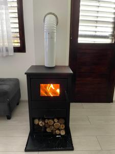 a stove with a fire in a room at Vikendica Uvac in Priboj