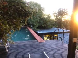 a house with a swimming pool on a wooden deck at Container stories in Bloemfontein