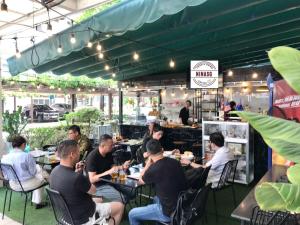 a group of people sitting at tables in a restaurant at 2 Bedrooms Scenic valley Big Free: Breakfast, Massage, More Discount Supermarket in Ho Chi Minh City