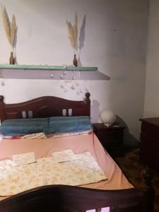 - une chambre avec un lit doté d'une tête de lit en bois dans l'établissement Don Zoilo Alojamientos, à Belén