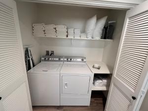a small kitchen with a white stove and plates at Fish Lake Suite - Castle Rock Condos in Richfield