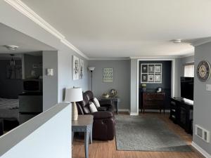 a woman sitting in a chair in a living room at Lazy Dayz Vacation Rental in Picton