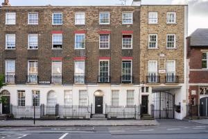 a large brick building with windows on a street at Livestay-Charming London Retreat Stylish 1BR near Kings Cross&Farrington in London