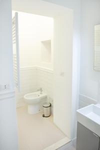 een witte badkamer met een toilet en een wastafel bij Minerva Boutique Residence in Rome