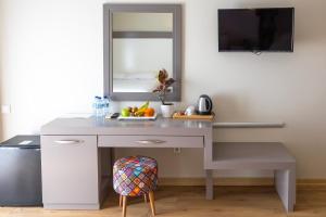 a white desk with a mirror and a plate of fruit at Mene City Hotel in Antalya