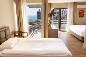 a hotel room with a bed and a balcony at Mene City Hotel in Antalya