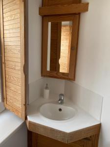 a bathroom with a sink and a mirror at HOTEL de la PLAGE in Wissant