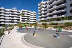 a playground in front of a apartment building at Arenales Bahia Penthouse in Arenales del Sol