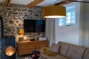 a living room with a couch and a fireplace at Chalet Weidehaus De Luxe 