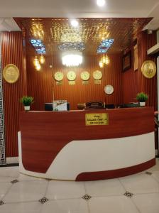 a counter in a restaurant with clocks on the wall at Dar Al Salaam Hospitality House in Nizwa