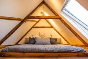 a bed in the middle of a roof at Chalet Sternenzauber in Waasen