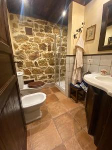 a stone bathroom with a toilet and a sink at seaside suite in paradise in Santuario di Gibilmanna