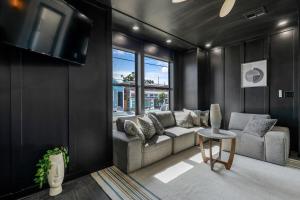 a living room with a couch and a tv at Celeste Rooftop Villa in New Orleans