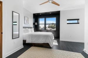 a bedroom with a bed and a ceiling fan at Celeste Rooftop Villa in New Orleans