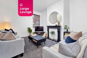 a living room with two couches and a fireplace at NEW Sackville House - Comfy 4 Bedroom House in Stoke on Trent