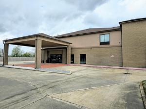 an empty parking lot in front of a building at Lucky Villa a boutique Hotel in Gonzales