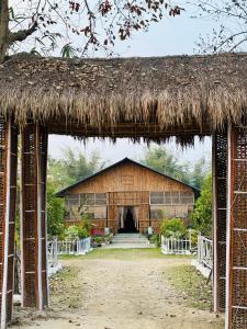 a large building with a straw roof at Kodom Bari Retreat, Kaziranga in Kāziranga