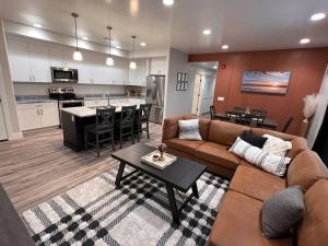 a living room with a couch and a table and a kitchen at Sunset Suite - Castle Rock Condos in Richfield