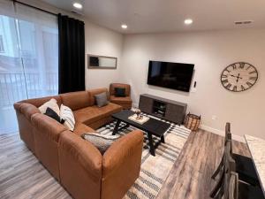 a living room with a couch and a clock on the wall at Sunset Suite - Castle Rock Condos in Richfield