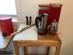 a table with a cutting board and utensils on it at Le Remous in La Malbaie