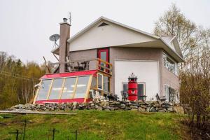 a house with a lighthouse on the side of it at Le Remous in La Malbaie
