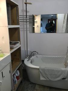 a bath tub in a bathroom with a mirror at Le Remous in La Malbaie +49 photos