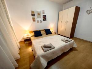 a bedroom with a large bed with blue pillows at Niko Apartments in Sunny Beach