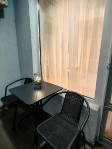 a table with two chairs and a lamp on it at Niko Apartments in Sunny Beach