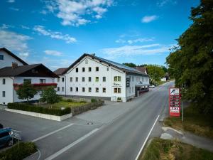 an empty street with white buildings on the side of a road at Landgasthof Wurm in Bogen