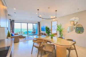 Il comprend une cuisine et un salon avec une table à manger et des chaises. dans l'établissement Yalkun's Home - The Sóng Condotel Vũng Tàu, à Vung Tau