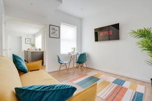 ein Wohnzimmer mit einem Sofa und einem Tisch in der Unterkunft Perfect Modern 4 bedroom in Liverpool in Liverpool
