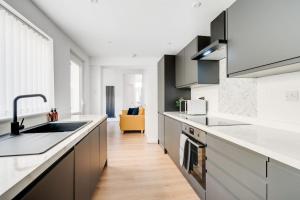 a kitchen with a sink and a counter at Perfect Modern 4 bedroom in Liverpool in Liverpool