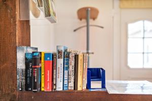 a row of books sitting on a book shelf at Ferienhaus Krakow am See in Krakow am See