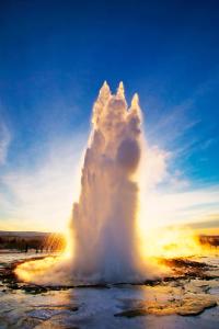 a geyser in the middle of a field at Myrkholt Cabin in Selfoss