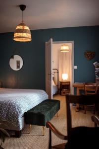 a bedroom with a bed and a table and a chair at Chez Guilem in Saint-Maixent-lʼÉcole