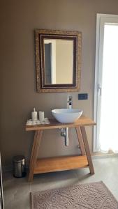 a bathroom with a sink and a mirror at NOTO country farm house in Noto