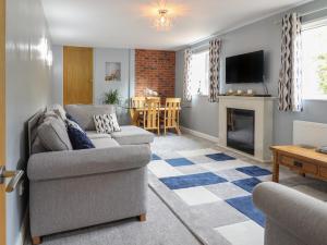 a living room with a couch and a fireplace at May Cottage in Llanfyllin