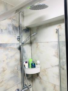 a bathroom with a shower with a sink at Double Room Near Tower Bridge 403 in London